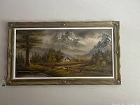Full view of the landscape painting with wood frame hung on a wall.