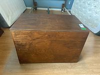 Top view of the wooden trunk showing smooth flat surface with visible wood grain.