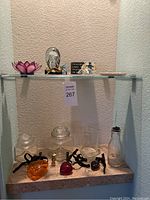 Moderate view of entire shelf with all items visible including motivational block sign and glassware items.