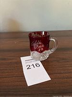 Ruby red etched glass souvenir mug from the 1933 World's Fair with clear textured base and handle