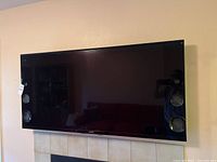 Front view of Sony TV mounted on wall showing full screen and built-in speakers