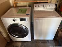 Front view of the Kenmore washer and Maytag dryer side by side in a garage or utility room.