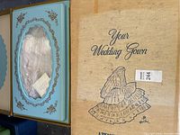 Original cardboard box labeled "Your Wedding Gown" featuring a vintage style illustration of a bride in a wedding dress, showing the unopened blue dress box with lace visible inside.