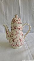 Front view of the floral pattern Broadhurst ironstone coffee pot with lid and handle.