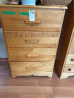 Front view of maple 4-drawer highboy, showing wood grain and drawer handles.