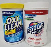Front view of OxiClean Versatile Stain Remover and Resolve Oxi Action Crystal White containers showing brand names, product names, and weight.