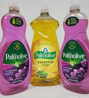 Front view of three Palmolive dish liquid bottles: two Ultra Lavender & Lime (purple liquid) and one Essential Clean Lemon Citrus Zest (yellow liquid).