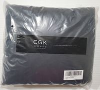 Front of packaged new CGK Linens sheet set in black, showing brand label and packaging.