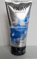 Front view of silver tube of Olay Regenerist Hyaluronic + Peptide 24 face wash, indicating 150 ml and fragrance-free.