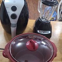 Front view of EcoChef Air Fryer, Rival Crock-Pot with glass lid, and Parini blender on table.