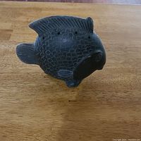 Photo showing the side view of the fish-shaped vessel with textured scales and dorsal fin with holes.