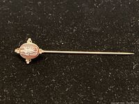 Full view of the 14KT gold stick pin with oval cameo and pearl accents.