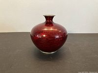 Full view of the antique vase showing round body and narrow neck with red cloisonne enamel detail.