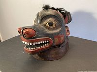 Three-quarter front view showing painted face and hair attached