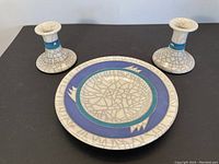 Set of raku pottery plate and two candle sticks, showing overall view and crackle glazing.