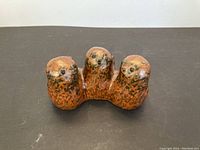 Front view of three bird sculptures