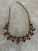 Full view of the necklace showing the chain and multicolored stones arranged symmetrically