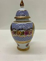 Front view of the Limoges ginger jar showing blue diamond lattice pattern, gold gilt and floral band