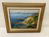 Frontal view of framed oil on board coastal landscape