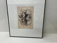 Framed lithograph artwork by Fernand Leger showing profile face and leaf design.