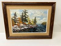 Full view of framed painting showing title scene and frame