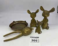 Full view showing the three brass mice figurines, the brass nutcracker, and small brass tray arranged on a white background.