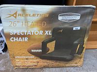 Box showing brand Aceletics, model 26" Heated Spectator XL Chair with warranty label.