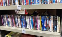 Shelf with a long row of DVDs including TV shows like 24, Buddy, Mr. Bean's Holiday, and others