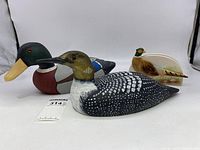 Three duck-themed items including two wooden duck decoys and a ceramic Otagiri napkin holder shaped like a pheasant, displayed on a white surface.