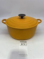 Yellow Le Creuset Dutch oven pot with lid, showing the full exterior from the front.