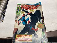 Front cover of The Amazing Spider-Man Comic Issue #86 showing Spider-Man and silhouette of Black Widow with comic text warnings.