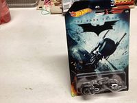 Unopened 2014 Hot Wheels Batman Batcycle in original blister card packaging with The Dark Knight theme.