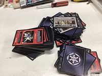 Two piles of Star Wars collectible cards with different backs and varied designs visible.