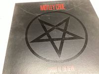 Front cover of the album sleeve showing the pentagram and album title.