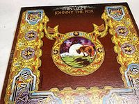Front cover sleeve of Thin Lizzy Johnny The Fox vinyl record featuring Celtic artwork and central fox scene.