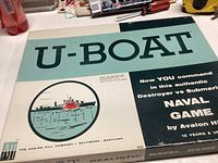 Close-up of the game's box with U-Boat title, ship illustration, and text about the game being naval strategy featuring Destroyer vs Submarine.