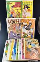 Photo of all 12 Liberty Meadows comics arranged upright and flat, showing colorful covers with female characters and animals.
