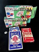 Full lot showing two boxes of poker chips, two Bicycle playing card decks and one Aviator deck