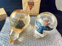 Two vintage liquid fire extinguishers labeled Toronto displayed on bubble wrap, one in original box.