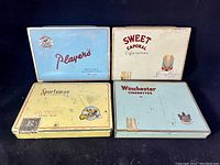 Top view of all four tins arranged in a 2x2 grid showing brand names and overall condition.