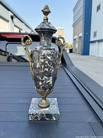 Front view of marble urn on square base showing overall shape and design