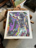 Full view of framed pop art print of Joey Ramone on a chair showing size and packaging.