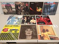 Photo showing front covers of 12 vinyl LP records from various artists arranged in a 3x4 grid