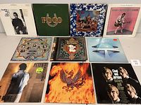 Front view of 10 vinyl albums arranged in two rows showing cover art.