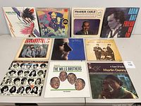 Front view of 10 vinyl albums with covers displayed, showing various artists and album artwork.