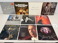 Front covers of 10 vinyl records arranged in two rows: The Silver Beatles, The Clancy Brothers and Tommy Makem, The Rolling Stones, Bobby Brown on top; Al Hirt, Mantovani, Styx and others on bottom row.