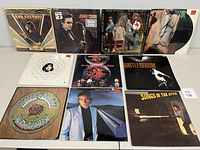 Front view of 10 vinyl album covers in a row showing various classic rock and folk artists.
