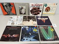 Front view of 10 vinyl albums showing their covers face up on table