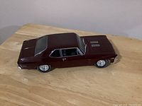 Side angle view of the maroon 1970 Chevrolet Nova SS diecast model car showing overall exterior condition and detailing.