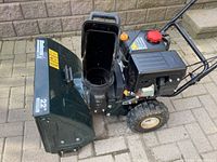 Side view showing intake housing, chute and engine assembly